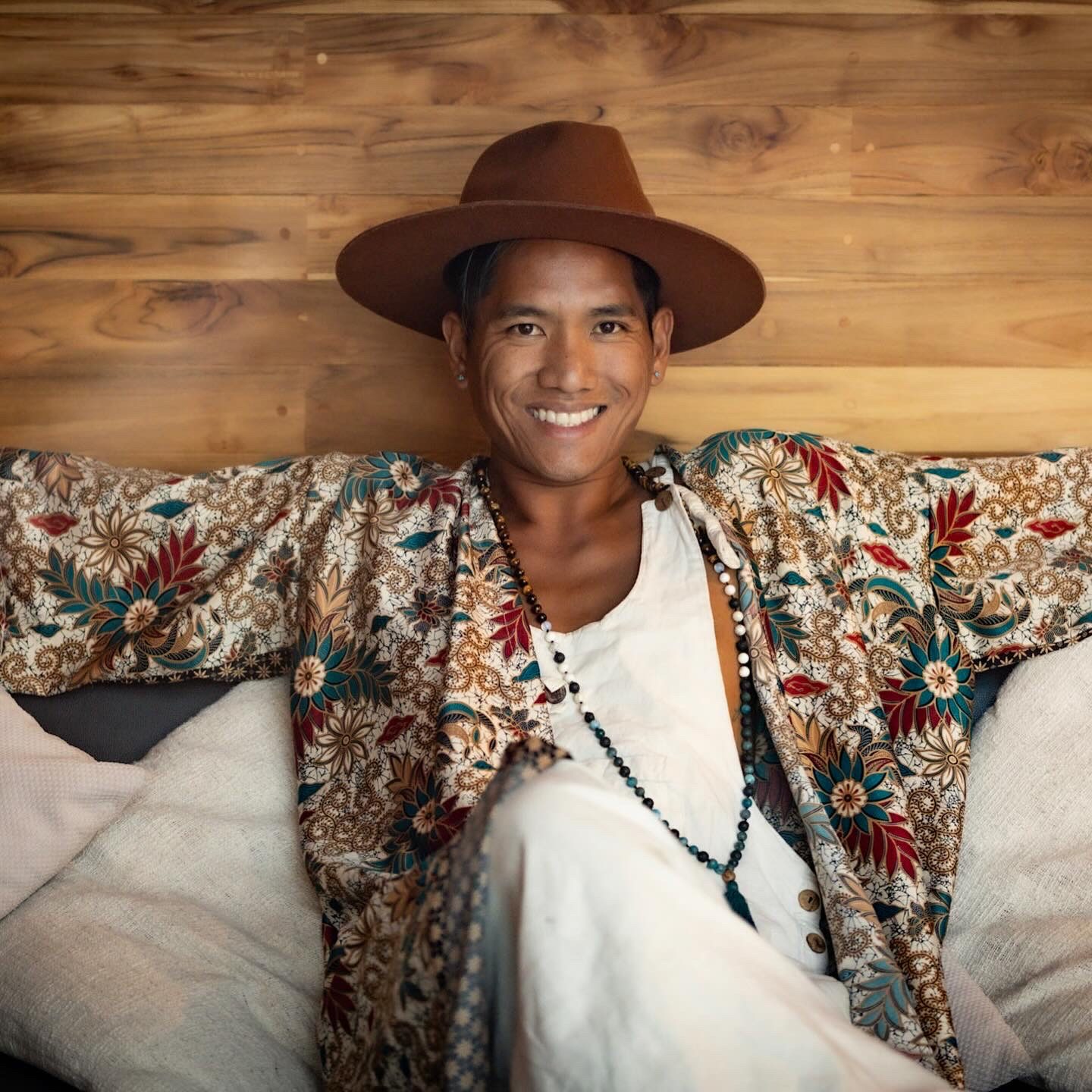Ryan smiling in a brown hat and patterned kimono
